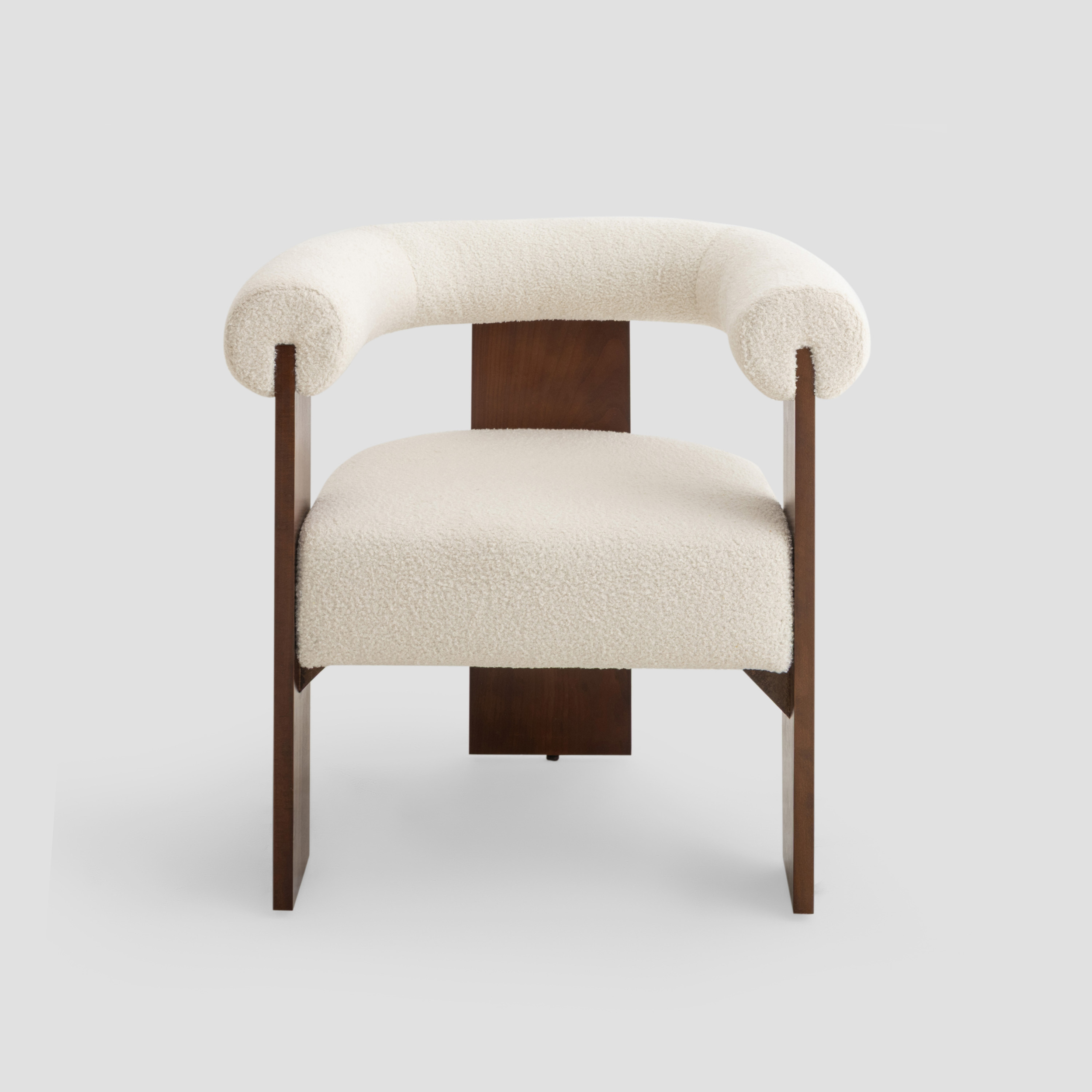 Ruby Curved Armchair in beech wood, featuring modern armchair and scandinavian styling, with cream and reading.