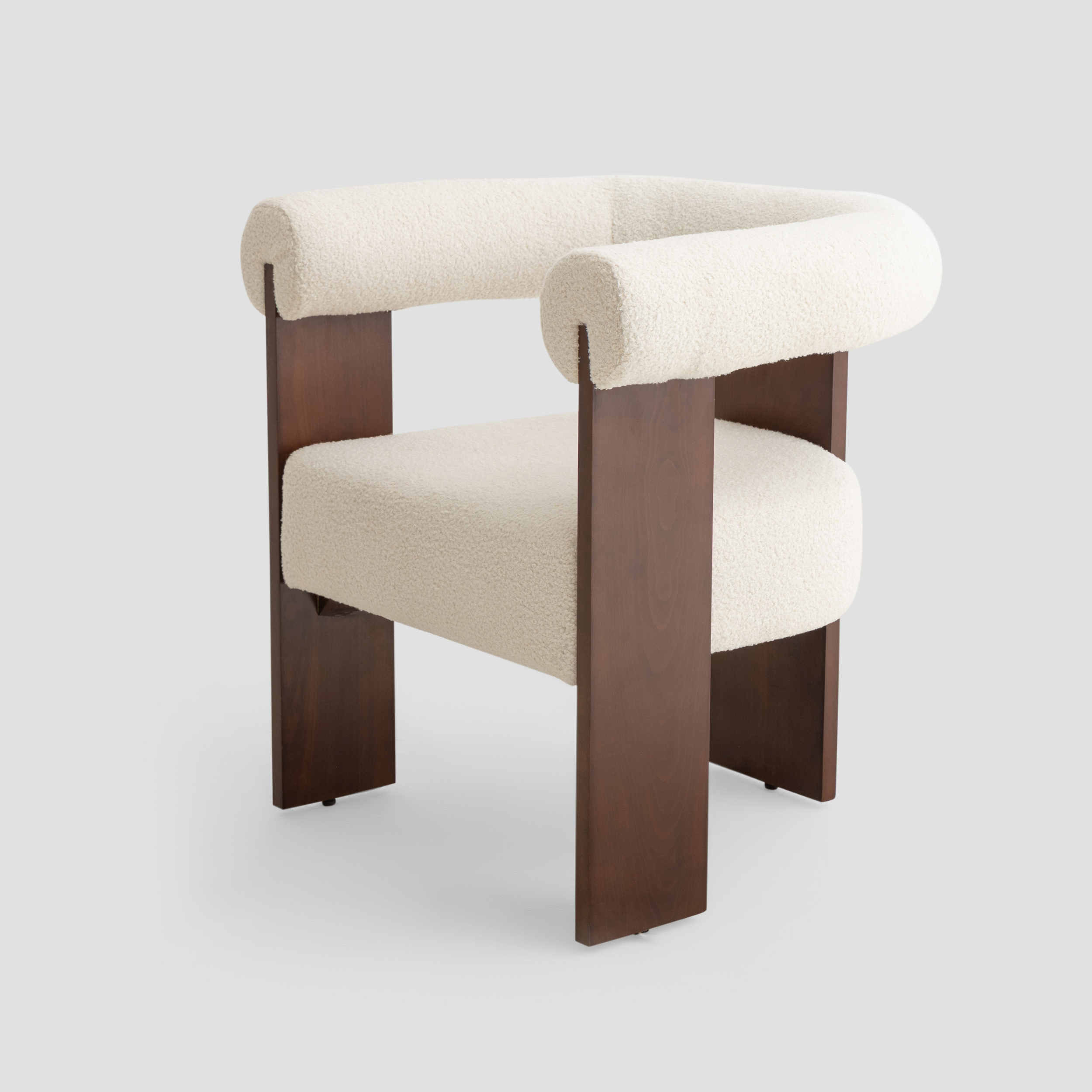 Ruby Curved Armchair in beech wood, featuring modern armchair and scandinavian styling, with cream and reading.