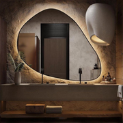 Tazia Freeform Wall Mirror, featuring modern styling, perfect for entryways, with black frame and abstract design.